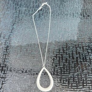 Two sided necklace one side is silver the other is cream colored